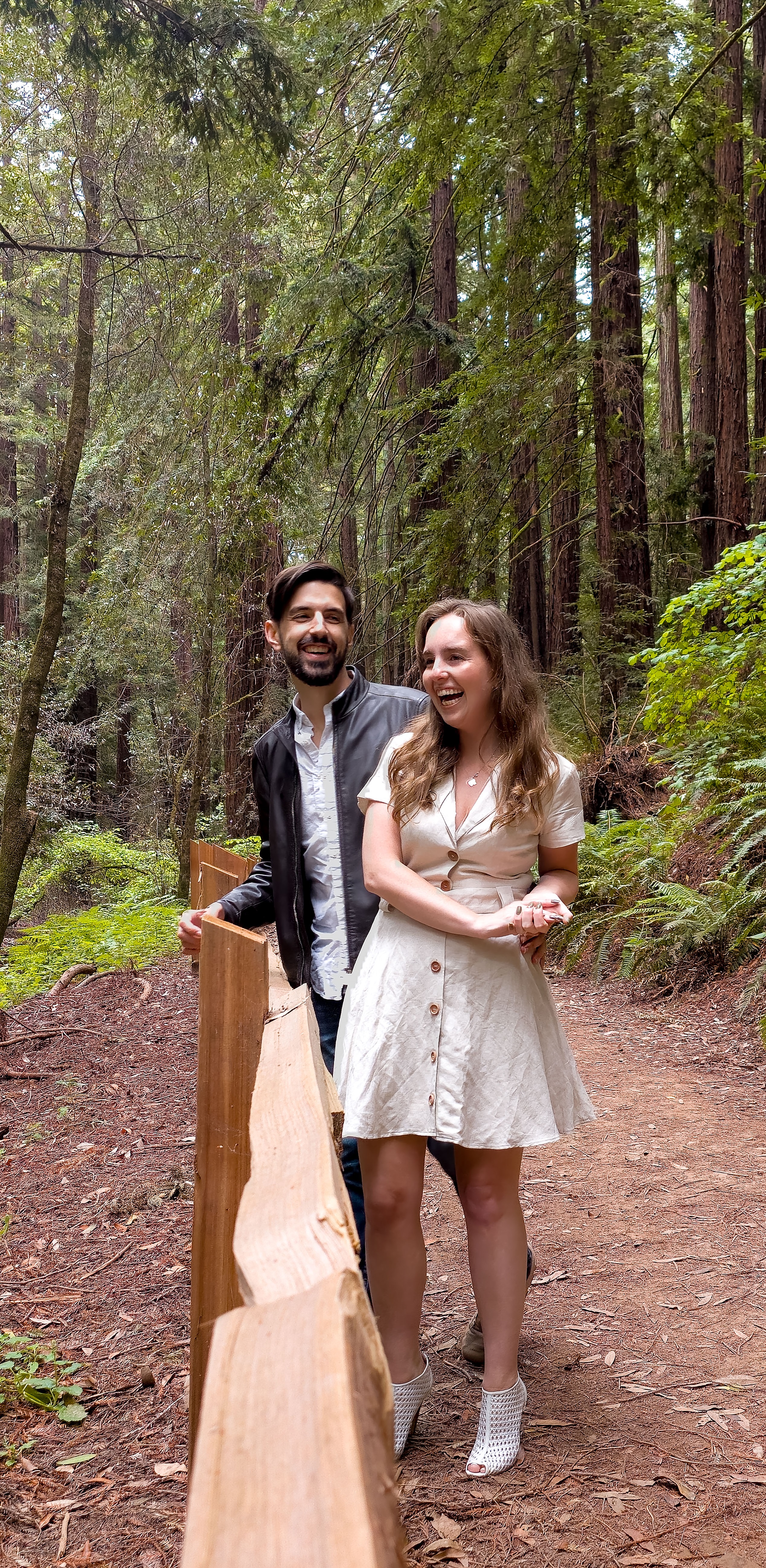 Natalie and Thomas side by side smiling in the Redwoods